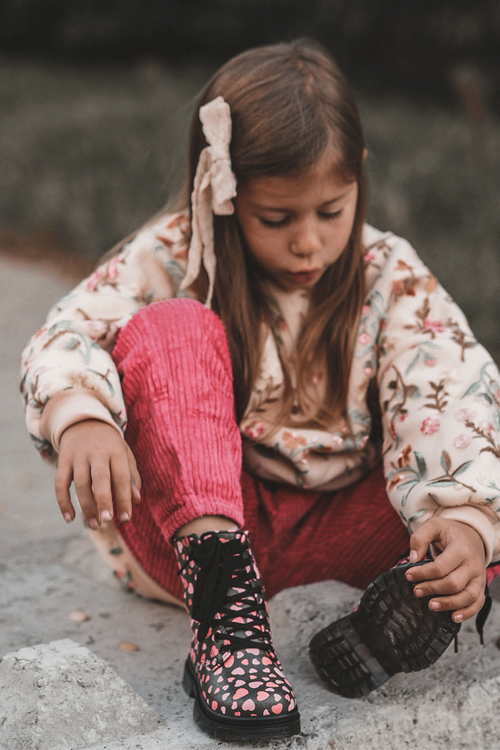 Izolované detské topánky na čiernom a ružovom posúvaní dolida